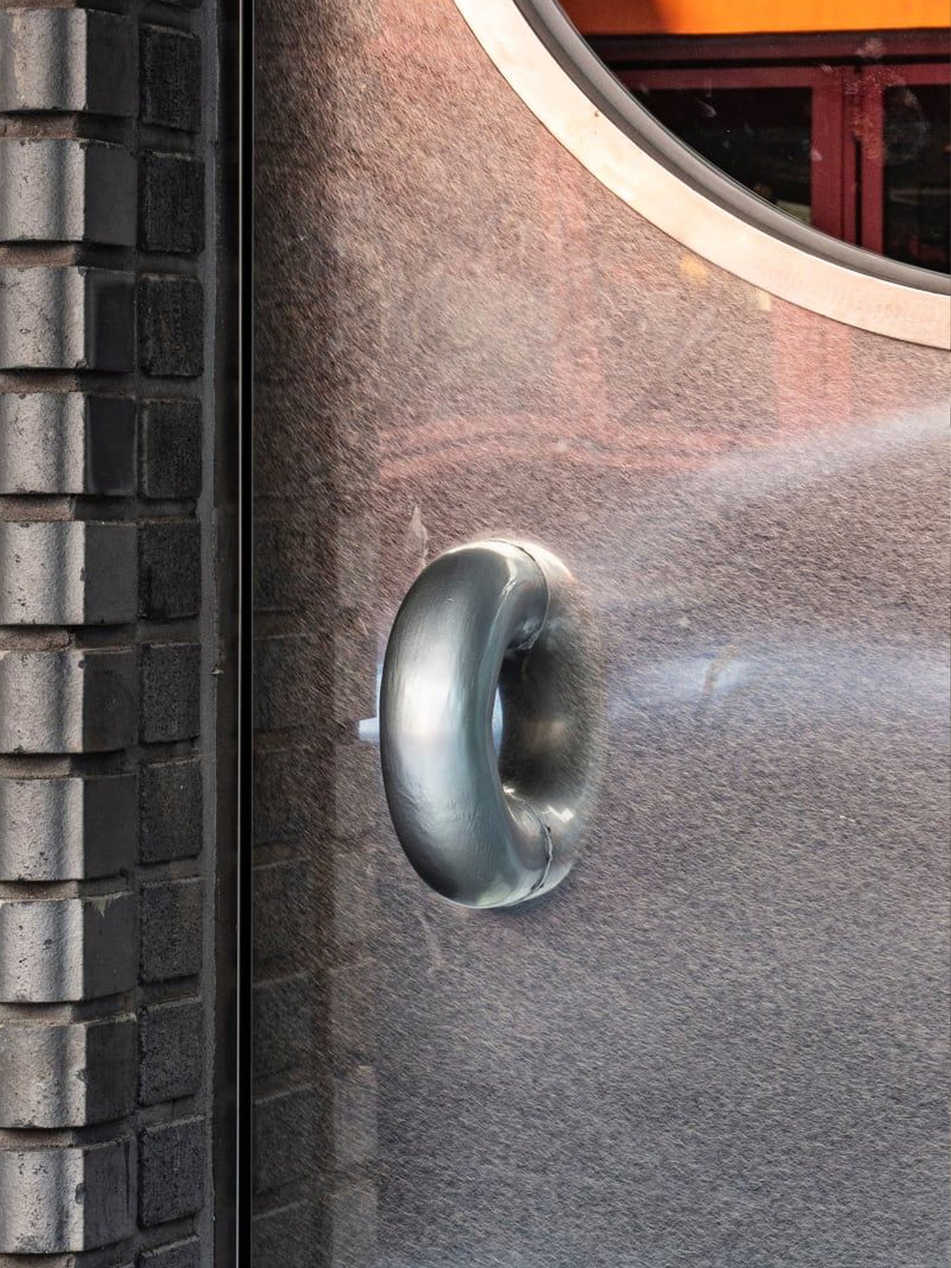 Close-up of a chunky door handle on a metal door