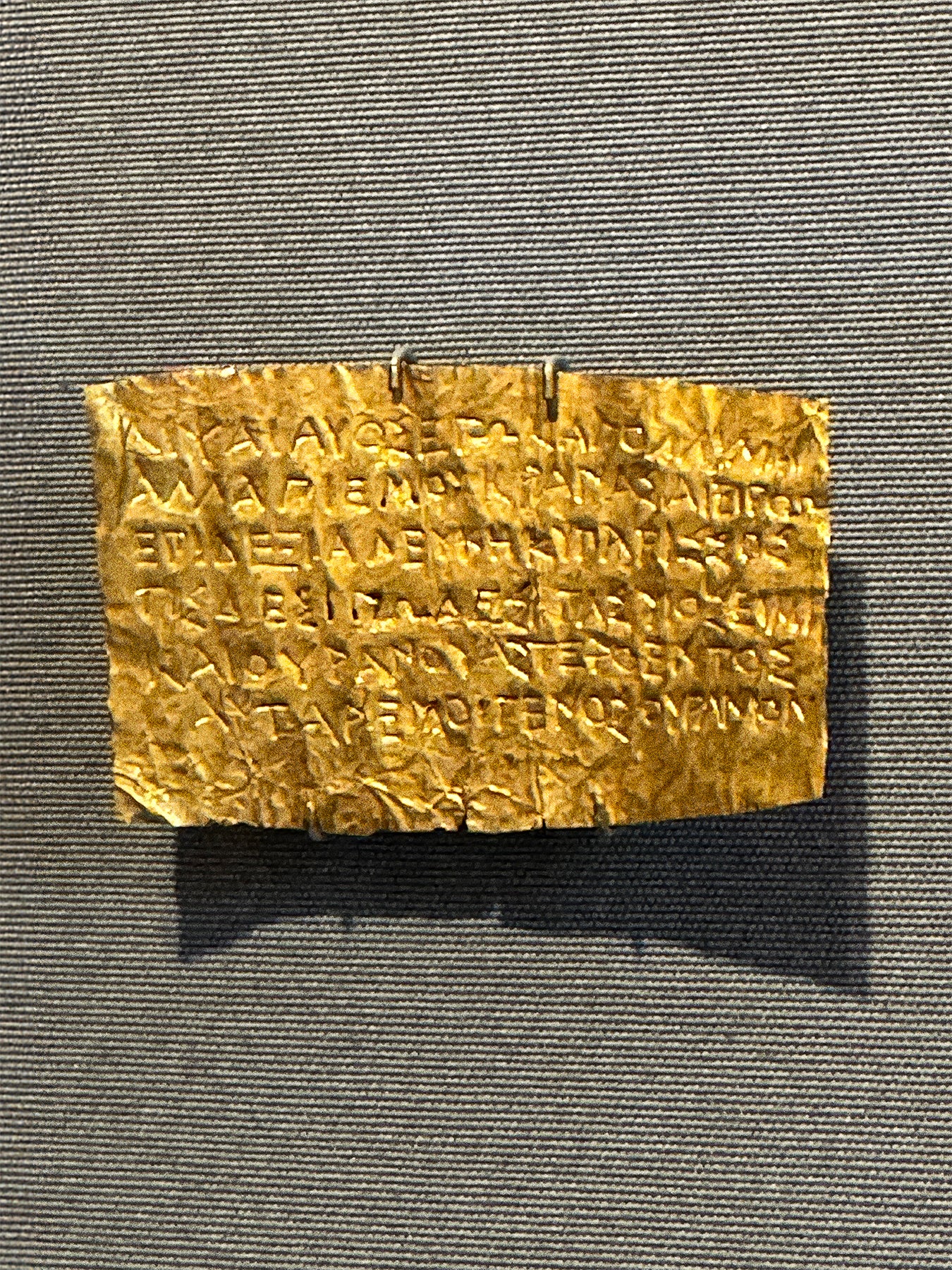 Gold inscription tablet on a gray background