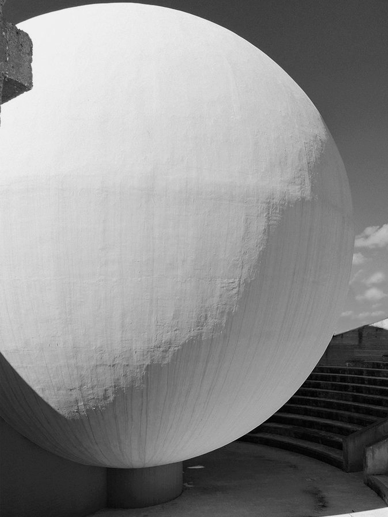 Close-up of a large spherical concrete structure with textural details.