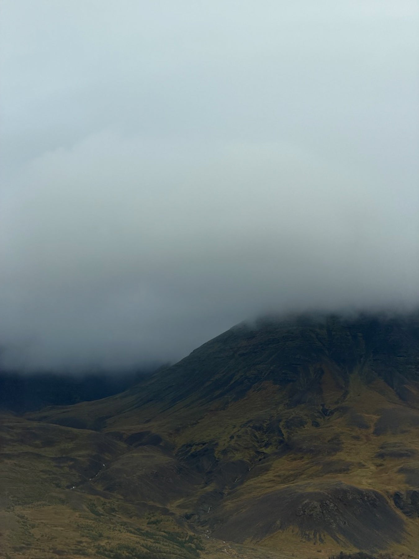 Mountain landscape with misty clouds covering the peaks