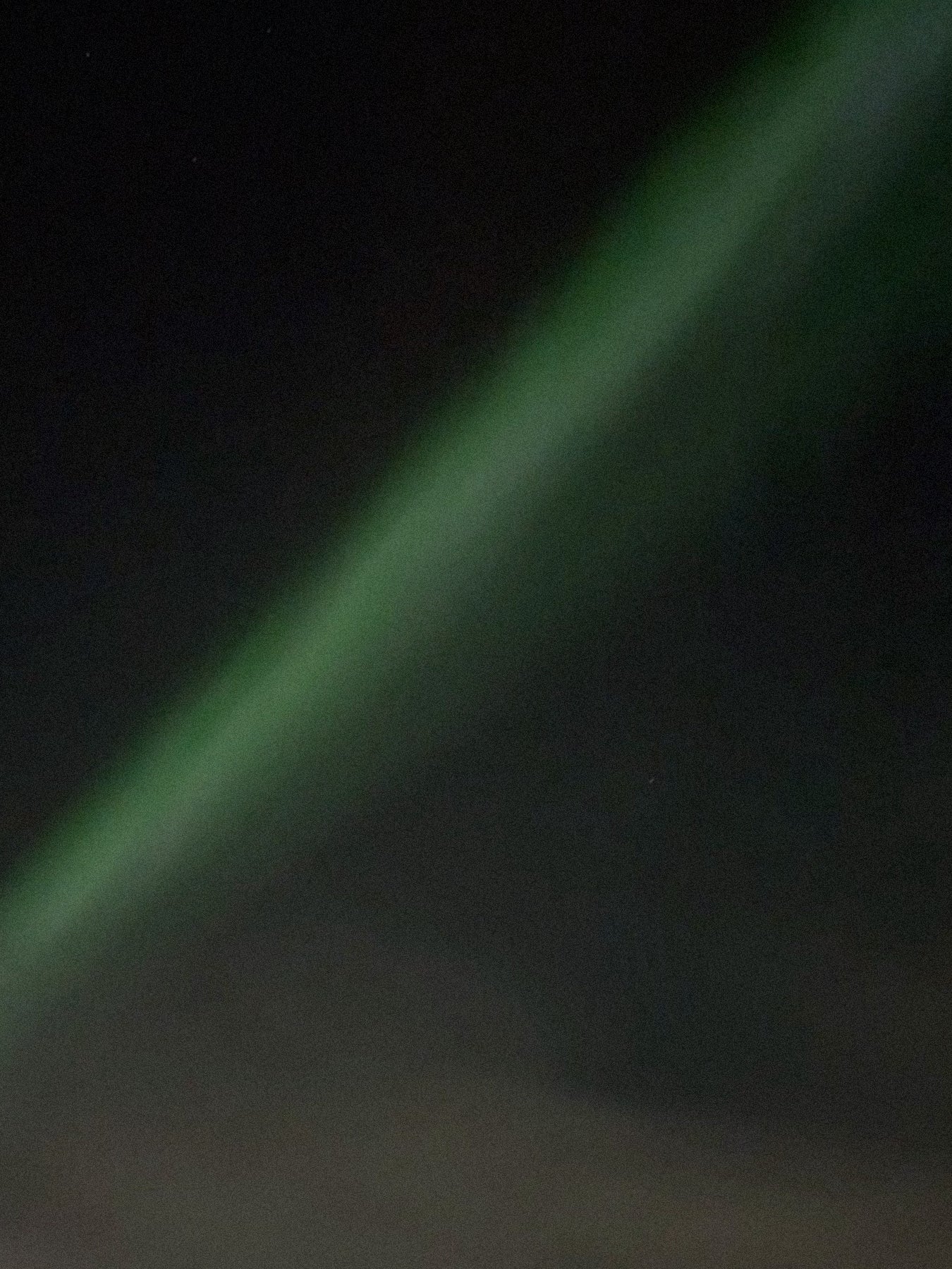 Nebula or galaxy image with green and blue colors on a dark background